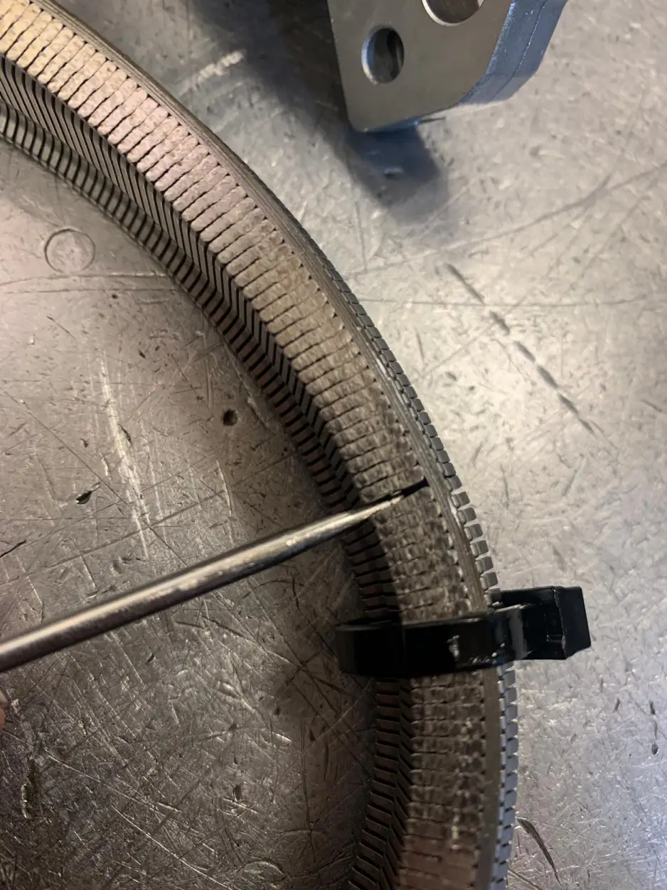 Detailed view of damaged Nissan gearbox oil pump seal being inspected under workshop lighting