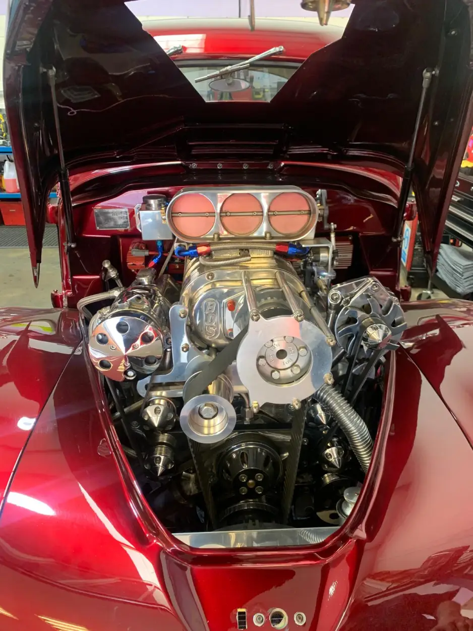 Front view of supercharged V8 engine bay in a Willys Coupe with polished BDS blower and braided hoses